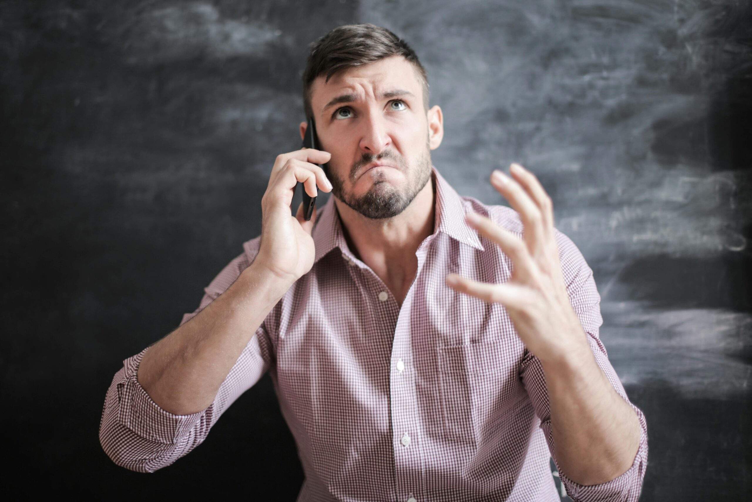 Hombre al teléfono con expresión de desesperación al hablar con uno de los bancos con más quejas ante la Condusef.