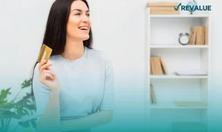 Mujer posando con su tarjeta de crédito que cuenta con seguro para tarjetas de crédito.