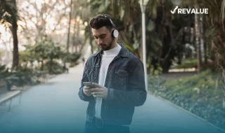 Persona caminando con calma en la calle con su celular gracias a que ha contratado el seguro Bancomer para celular.